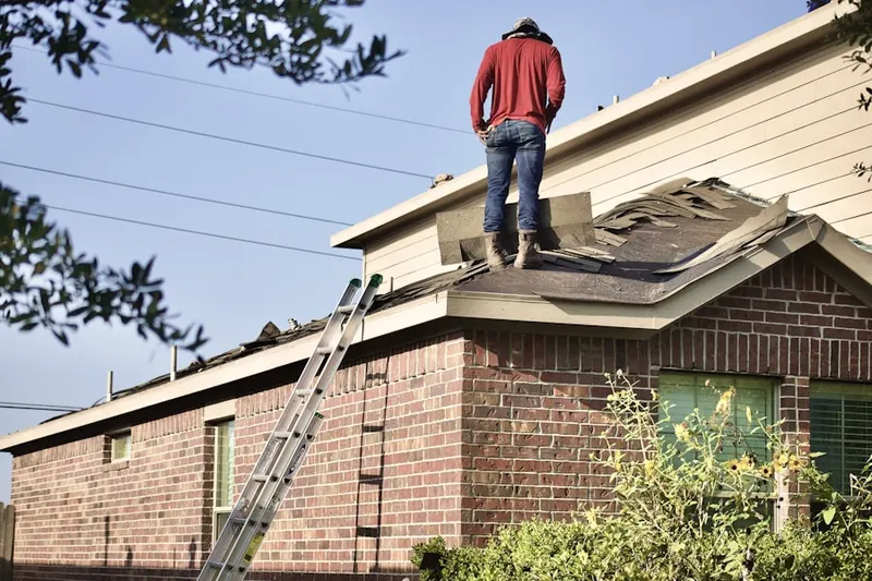 Professional roofer working on a residential roof in Brockmont